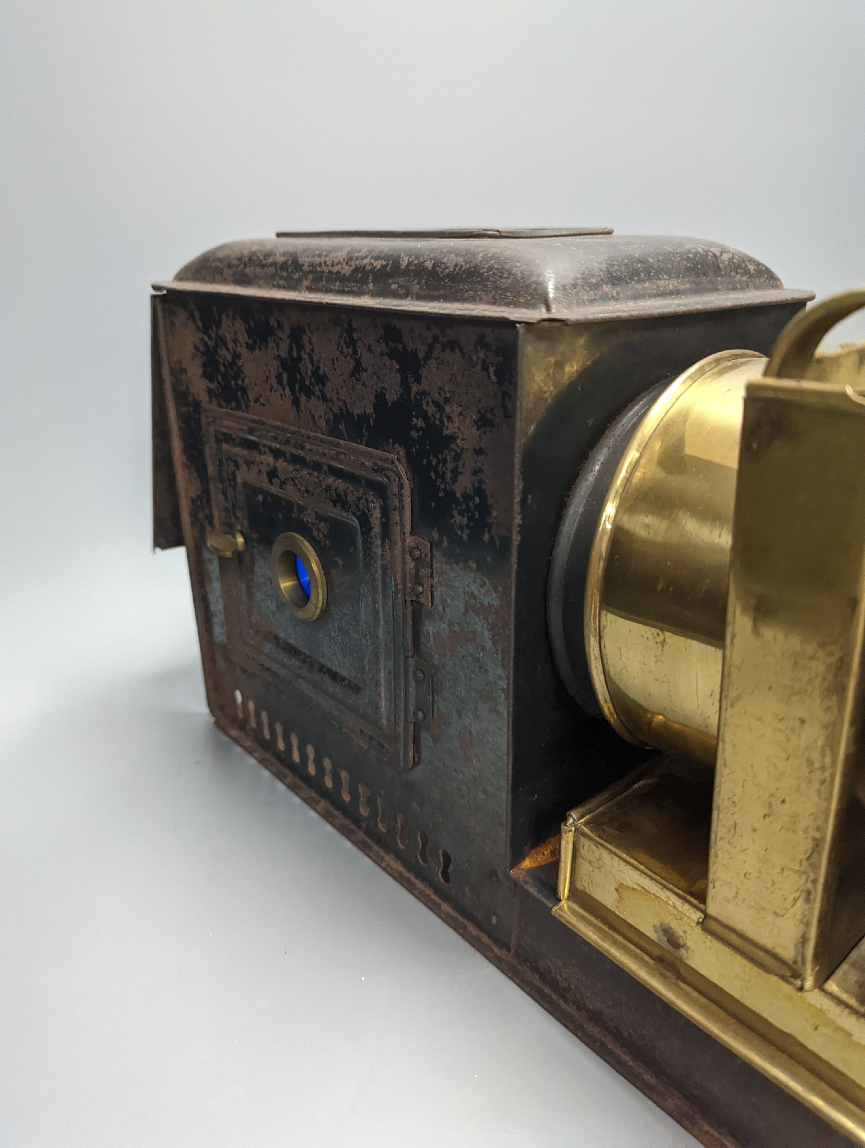 A cased tinplate and pressed brass Magic Lantern, Case 46 cm long